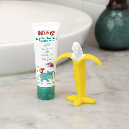 Dr. Talbot's Baby Toothbrush and Toothpaste sit side by side on a bathroom countertop, offering a playful and effective solution for early oral care.