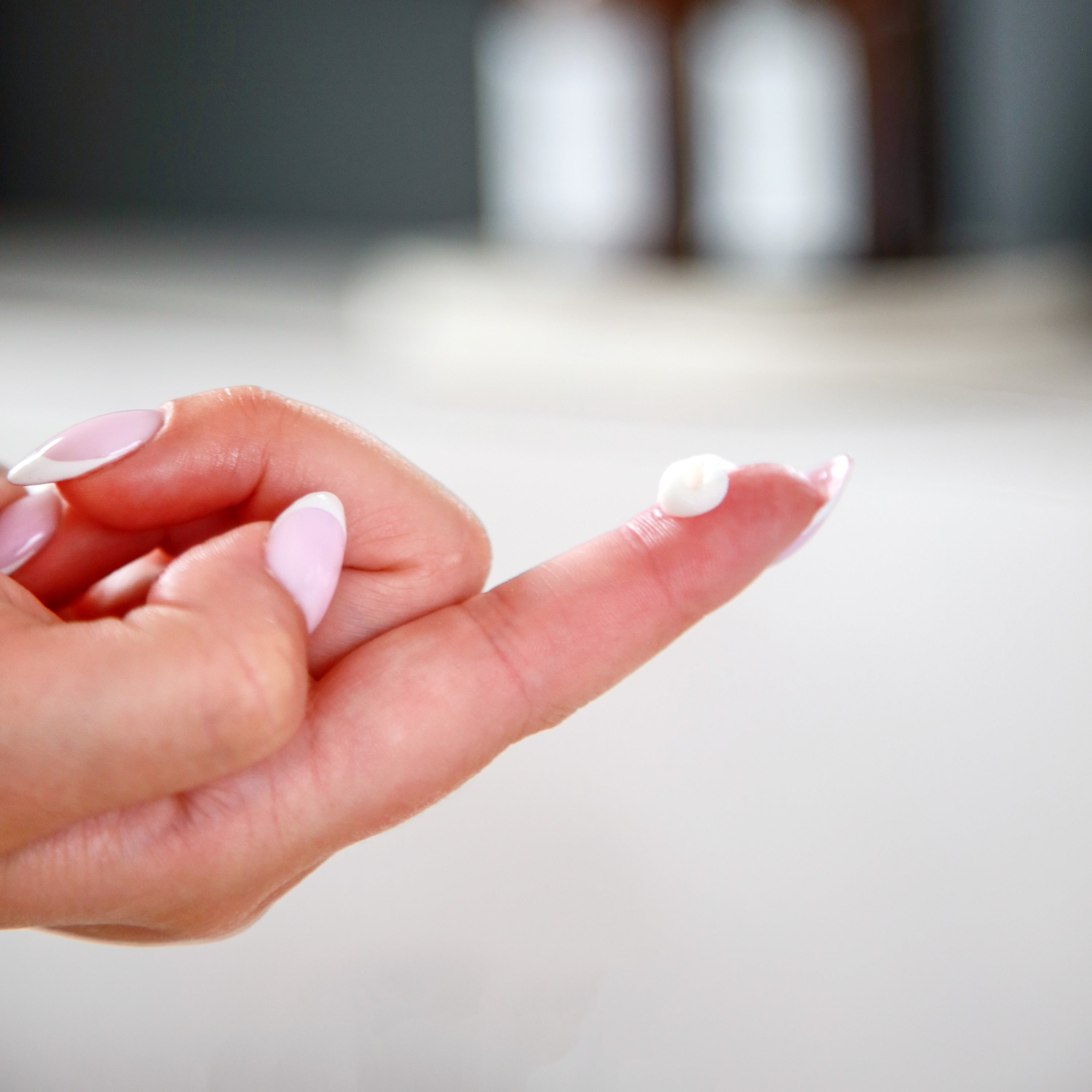A small dab of white Dr. Talbot’s Mom Pregnancy & Postpartum Hemorrhoid Ointment on the tip of a finger.