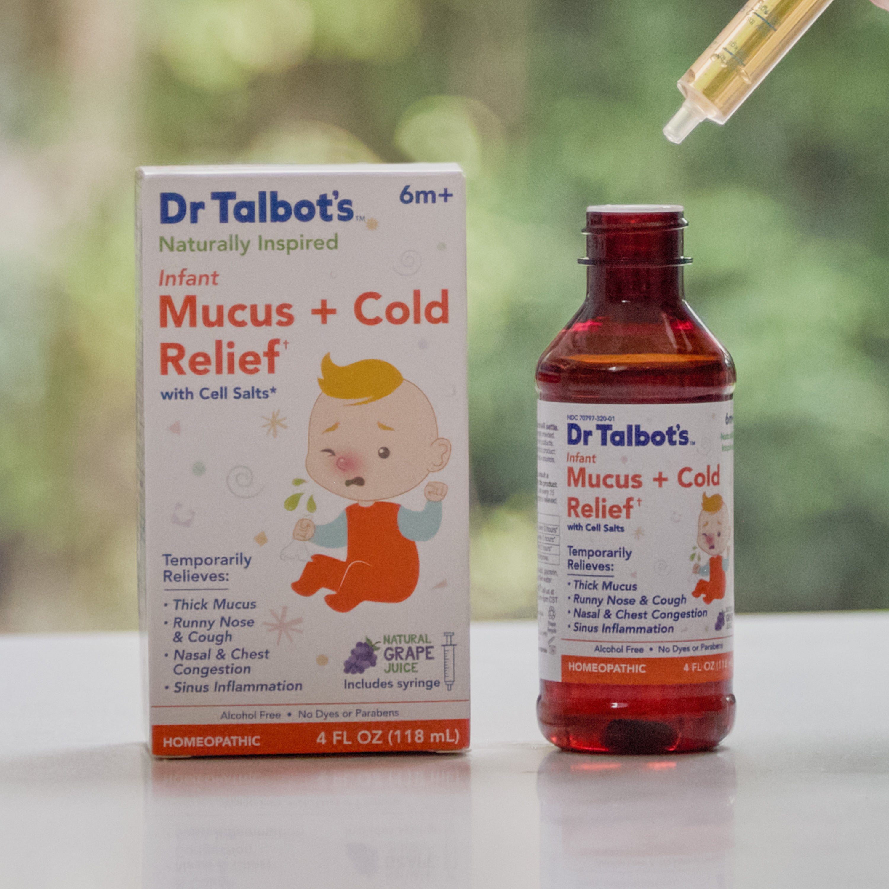 Dr. Talbot’s Infant Mucus + Cold Relief bottle and box, with a dropper filled with liquid held above the open bottle.