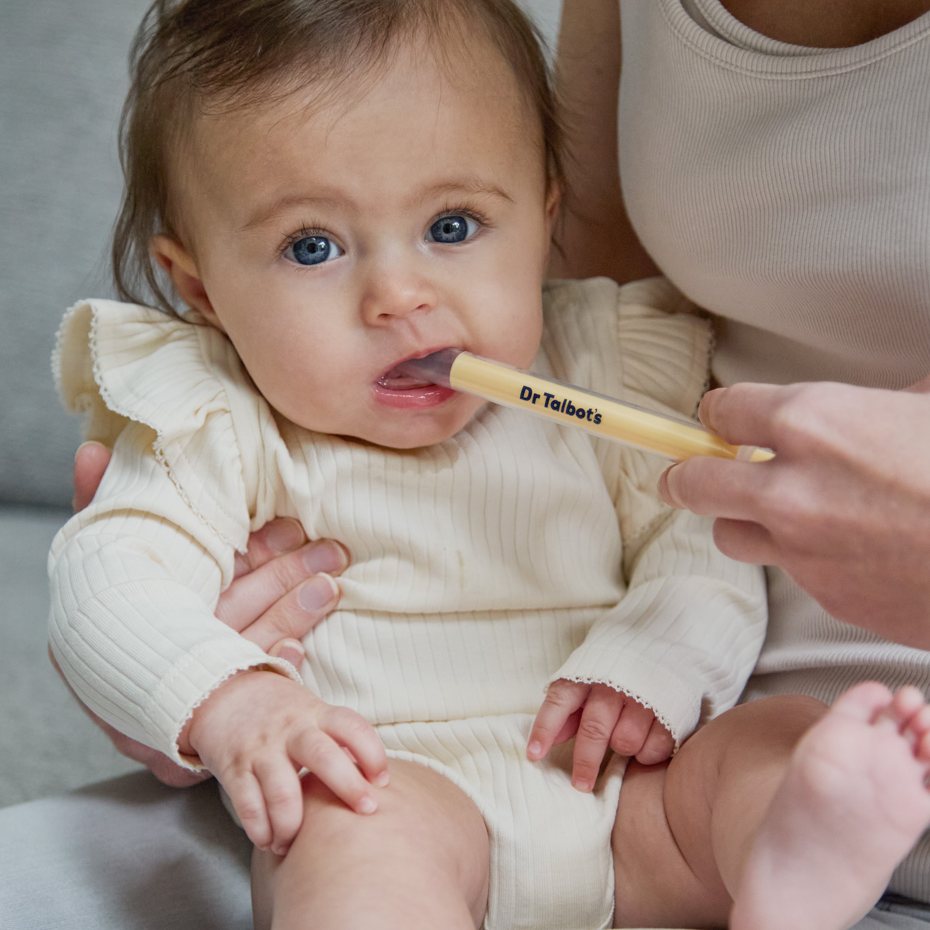An adult uses a clear plastic Dr. Talbot’s Sure-Dose™ Medicine Syringe to gently administer an accurate dosage of medicine to a baby.
