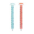 Four Dr. Talbot’s Sure-Dose™ Medicine Syringes are displayed upright side by side on a white background—two blue and two red—each featuring clear measurement markings for precise dosing, making them ideal as baby dosage syringes or medicine dispensers.