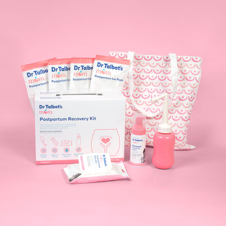 The Dr. Talbot’s Mom Postpartum Recovery Kit features a patterned tote, peri bottle, wipes, postpartum underwear, and perineal ice pads—perfect essentials for vaginal birth, all displayed on a pink background.