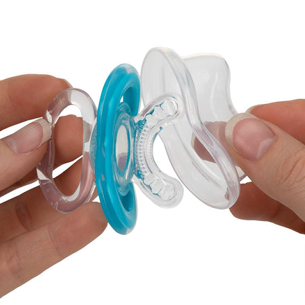 A close-up of hands holding Dr. Talbot's Soothing Gel + Gum-EEZ Teether with a blue ring and textured nipple, showing the separated front, side, and back parts designed to gently soothe baby's gums.